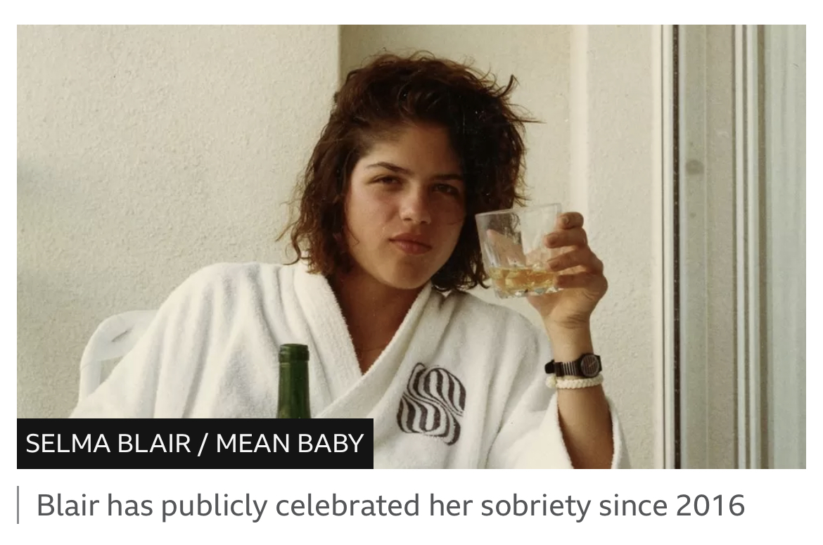 photo of Selma Blair holding a glass of alcohol, with the caption “Blair has publicly celebrated her sobriety since 2016”
